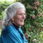 Smiling gray-haired woman in garden