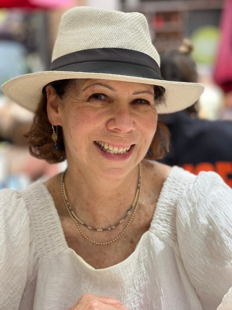 Smiling woman wearing a wide-brimmed hat