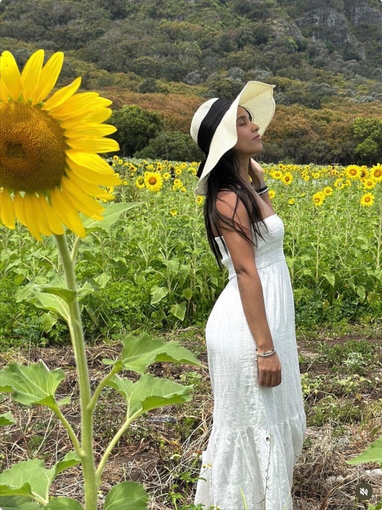 Woman in white dress in sunflower field