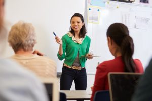 Teacher in front of students at an adult education class